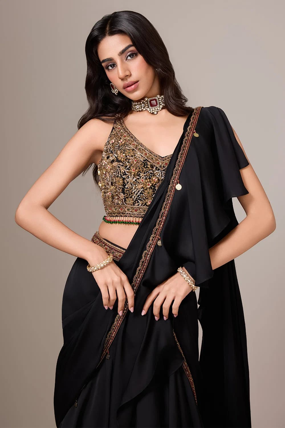 JET BLACK PRE STITCHED SAREE SET AND AN ANTIQUE GOLD HAND EMBROIDERED BLOUSE WITH AN ATTACHED DRAPED PALLU AND AN EMBROIDERED BORDER.